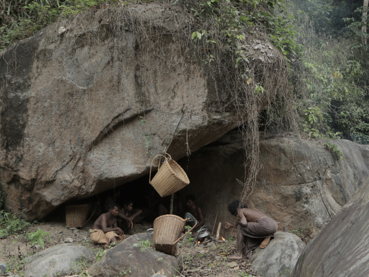 Some Cholanaikkans men cooking food over fire in a forest cave. Photo- KA Shahji