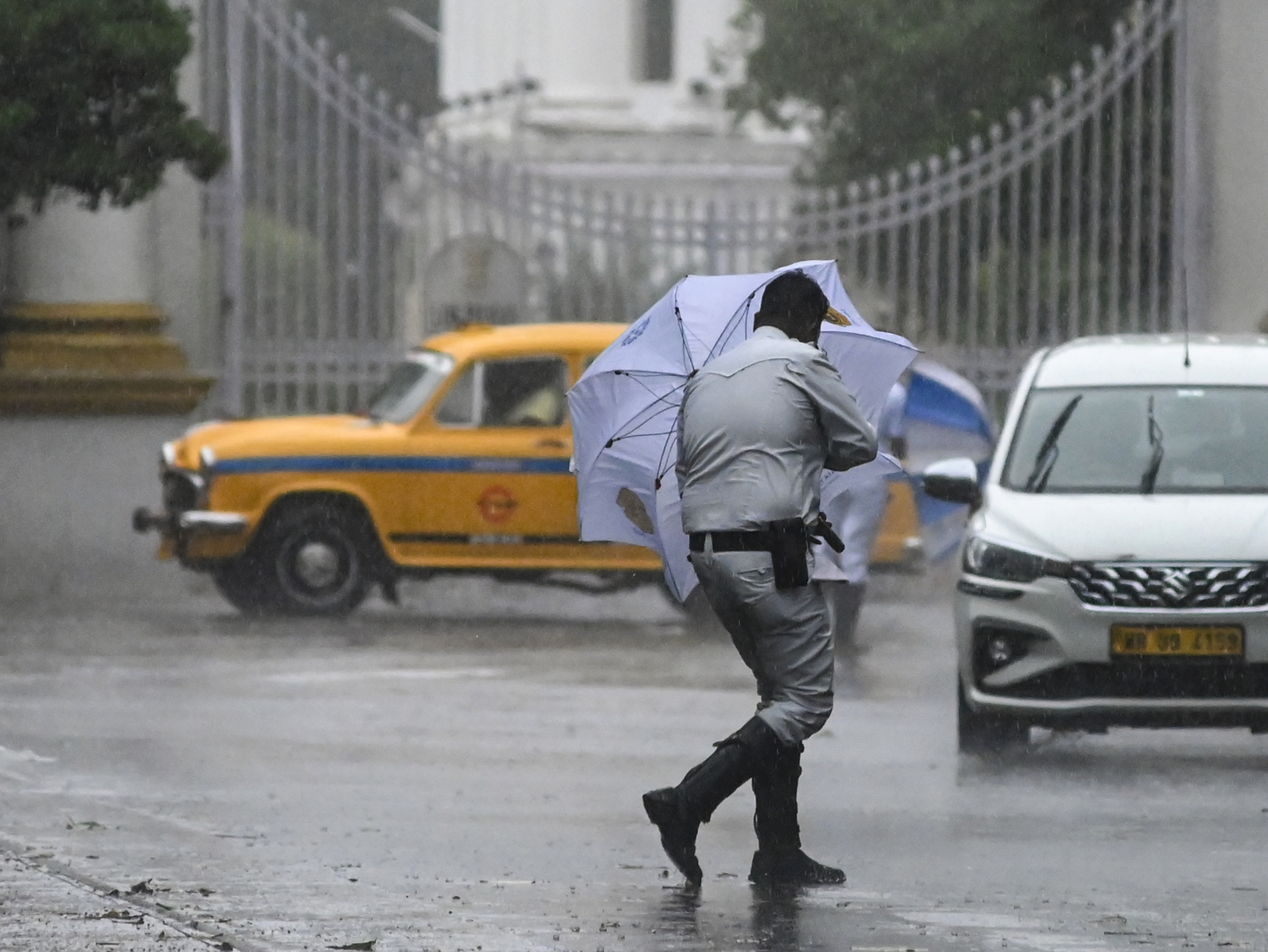 Imd Heatwave End In India| Rain In Mp Up Rajasthan 5 पश्चिम बंगाल के कोलकाता में रविवार दोपहर बारिश हुई। तेज आंधी के कारण पुलिसकर्मी का छाता पलट गया।