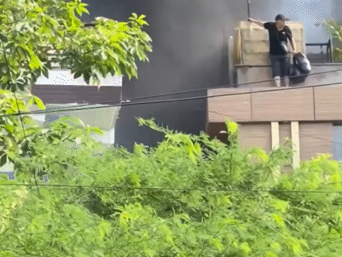एक विदेशी आग लगने के बाद जान बचाने के लिए छज्जे (बालकनी) पर खड़ा हो गया।
