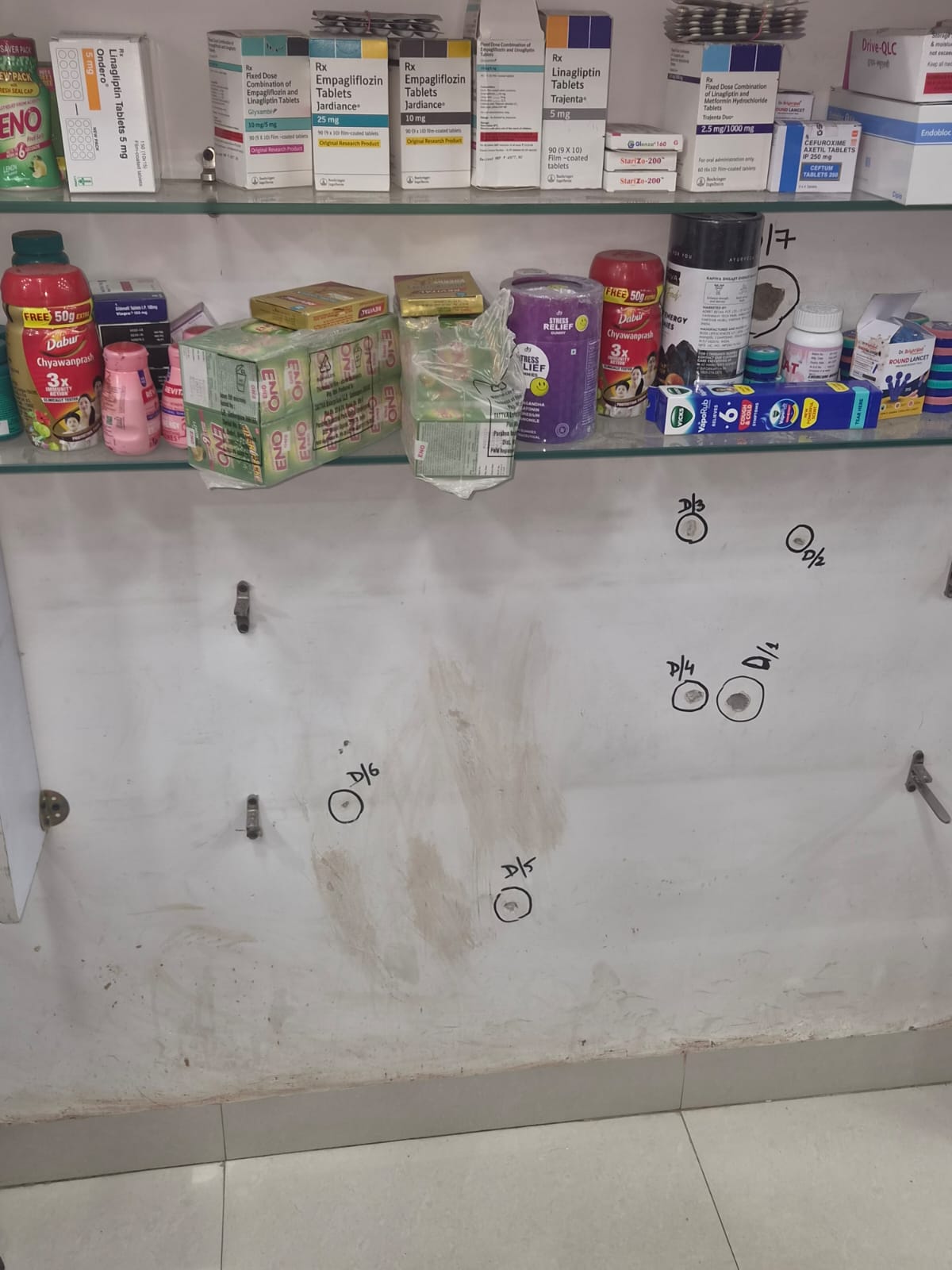 When Shri Kumar Medical Hall opened on Monday, the police there marked the places where the bullets of the attackers had hit.