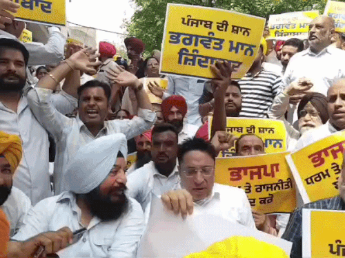 नारेबाजी करते हुए आप कार्यकर्ता।