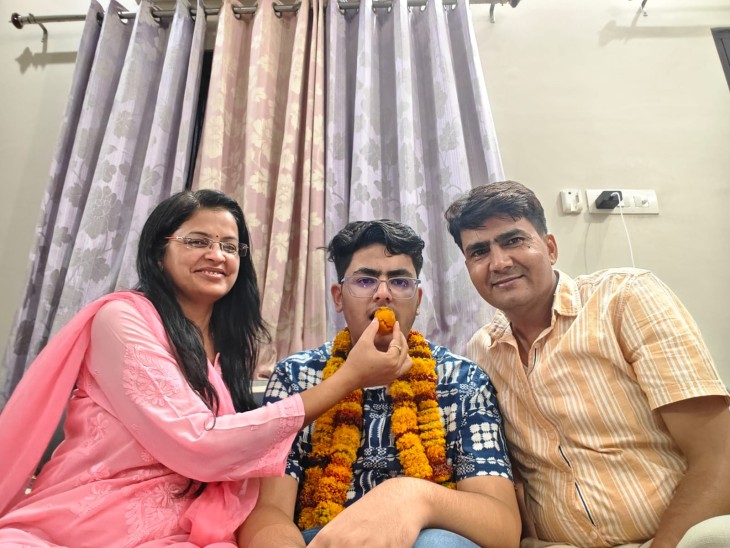 छात्र ईशान कटारिया को मिठाई खिलाने माता-पिता