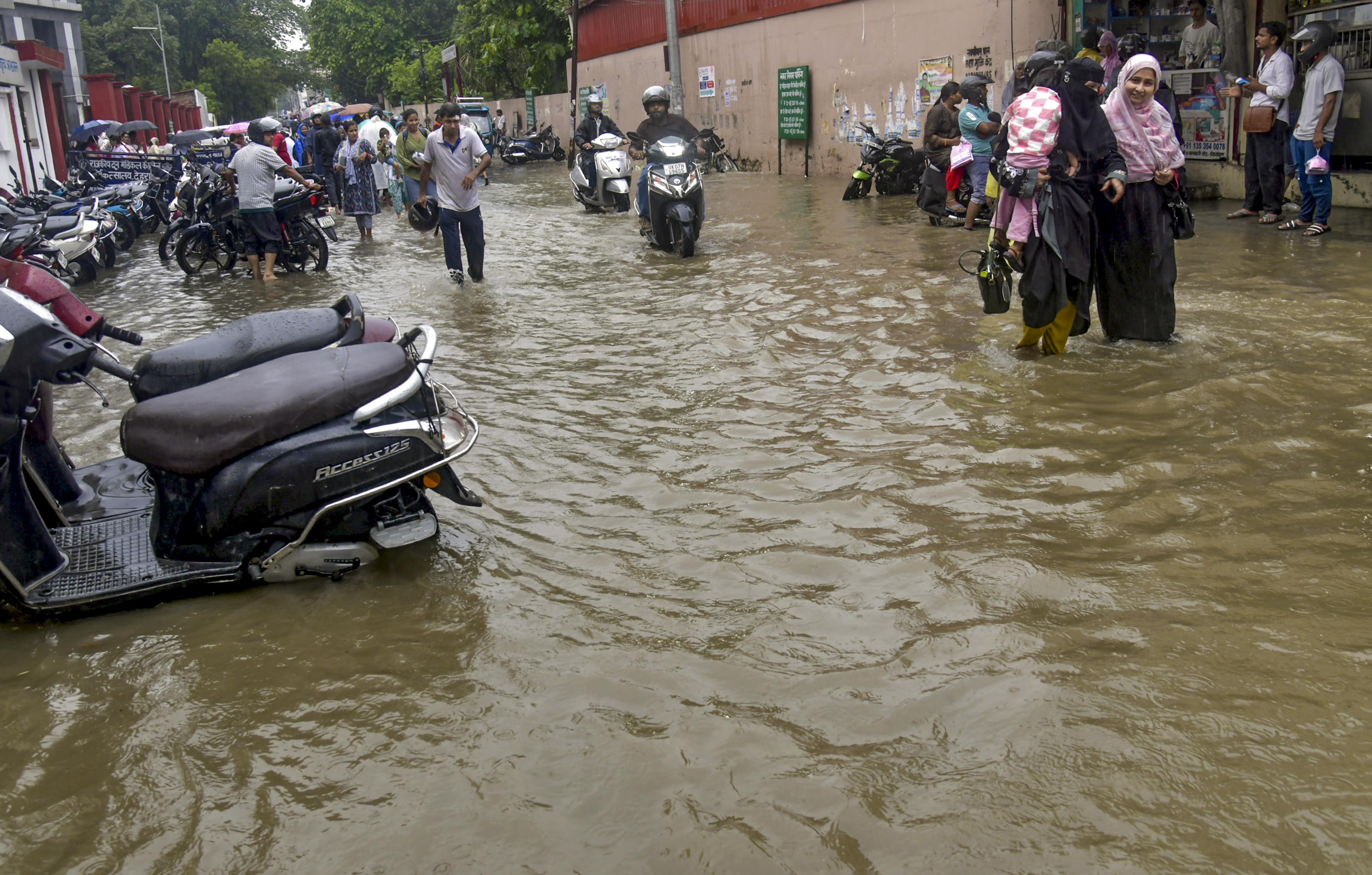 Roads were flooded after heavy rainfall in Dehradun, Uttarakhand. People had to wade through these waterlogged streets.