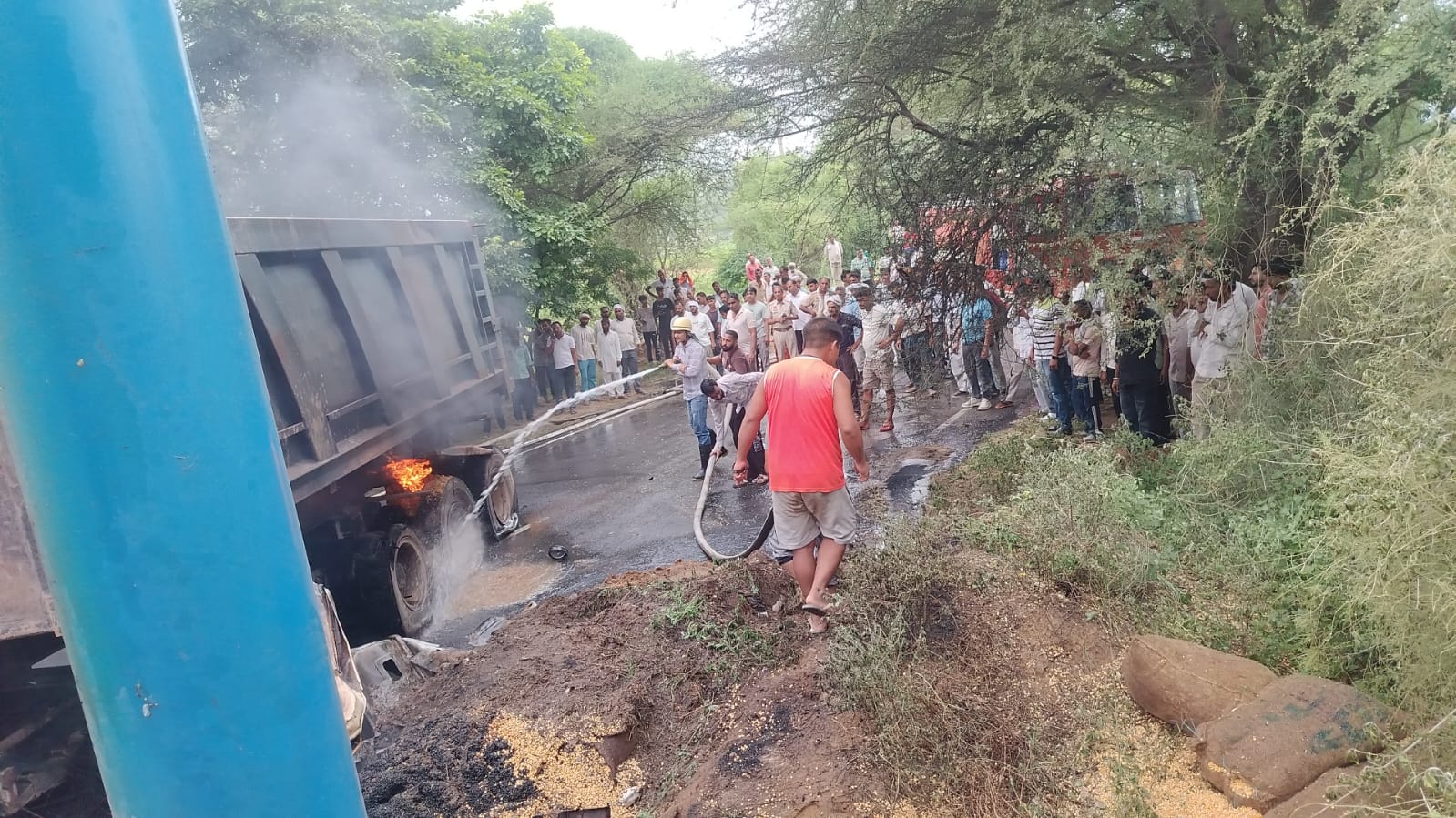 ग्रामीणों के साथ ट्रक और डंपर में लगी आग बुझाते फायर ब्रिगेड।