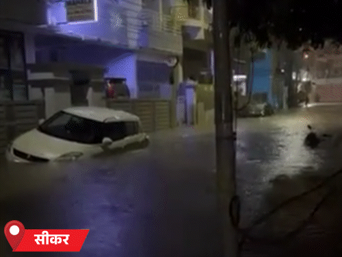 सीकर में तेज बारिश के कारण मंगलवार को गाड़ियां डूबी दिखीं। शहर को कई हिस्सों में तीन-चार फीट तक पानी जमा हो गया।