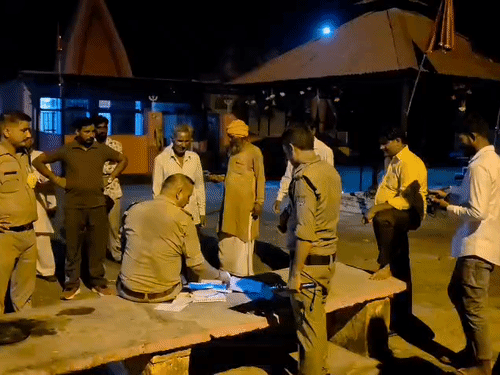 Police questioning people at the Shiva temple.