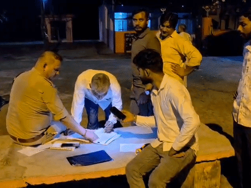 Police recording statements of people present nearby in writing.