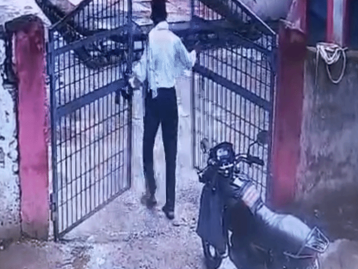 The accused teacher opening the school gate.