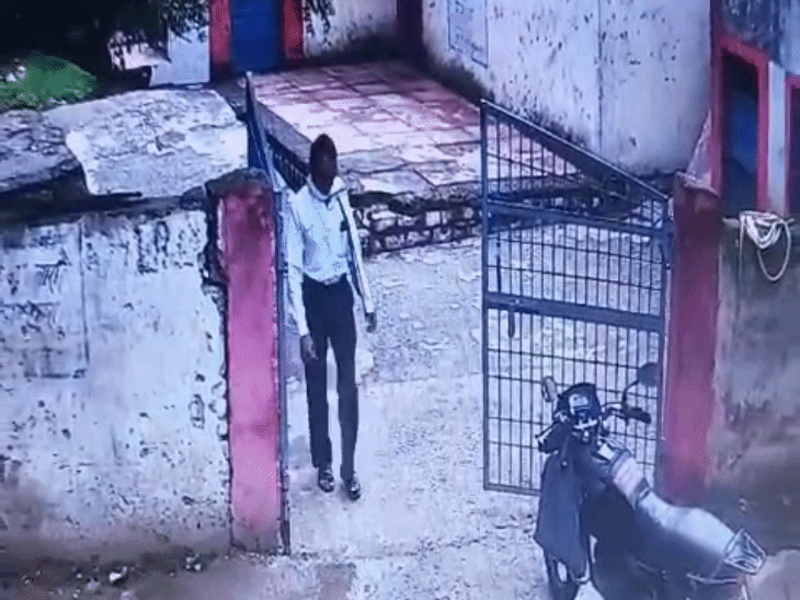 The accused teacher coming to pick up the vehicle after opening the gate.