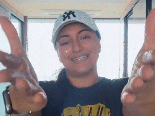 Sonakshi Sinha holding her ears and saying 'Dand Baith'.