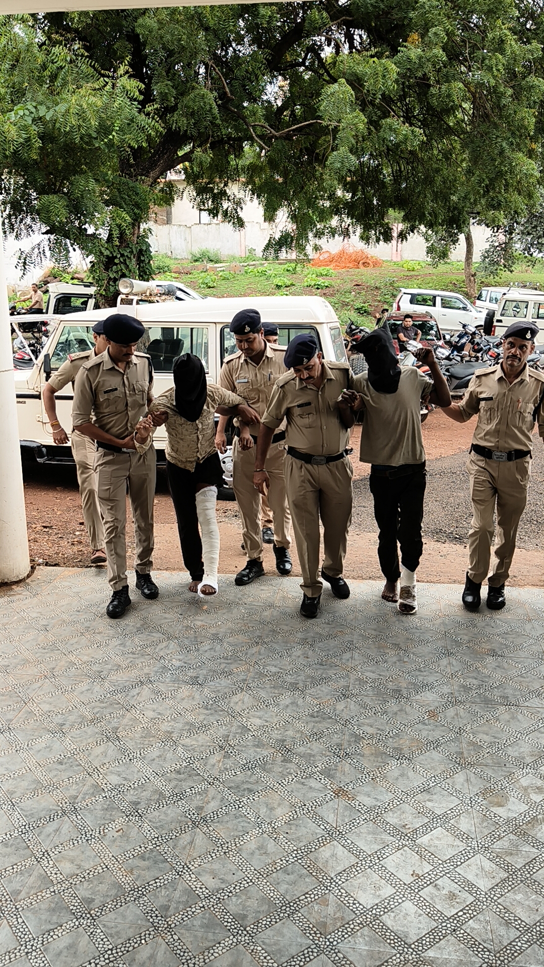 Police taking the accused away after he was injured.