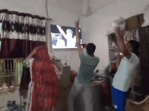 Family members celebrating Ankush's gold medal win in Bheria village, Hisar.
