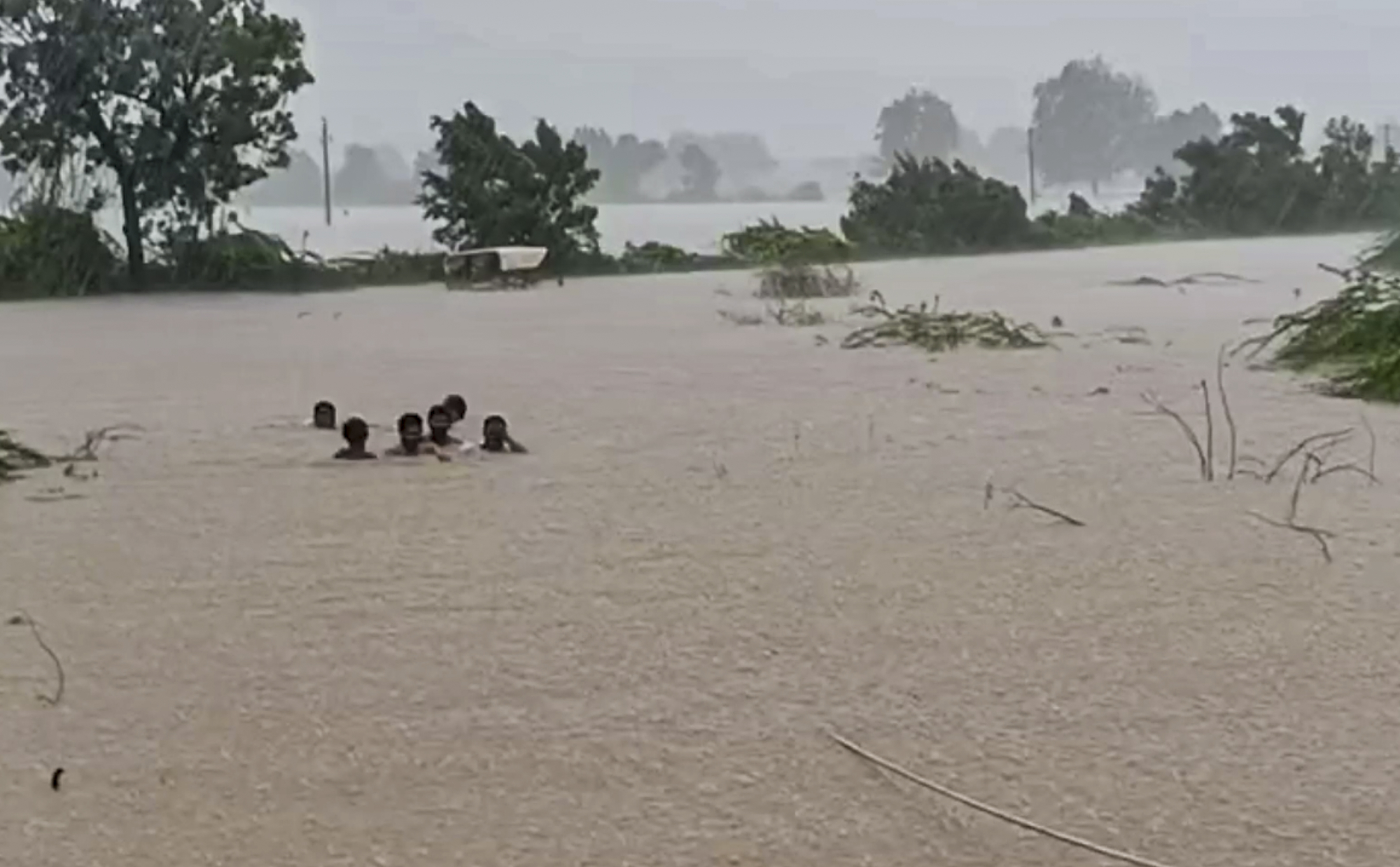 In many areas of Morbi, Gujarat, so much water accumulated that people were moving from one place to another with water up to their necks.
