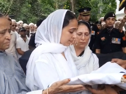 The army handed over the tricolor to the Major's wife.