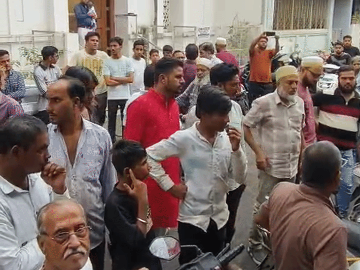 A crowd gathered outside the house.
