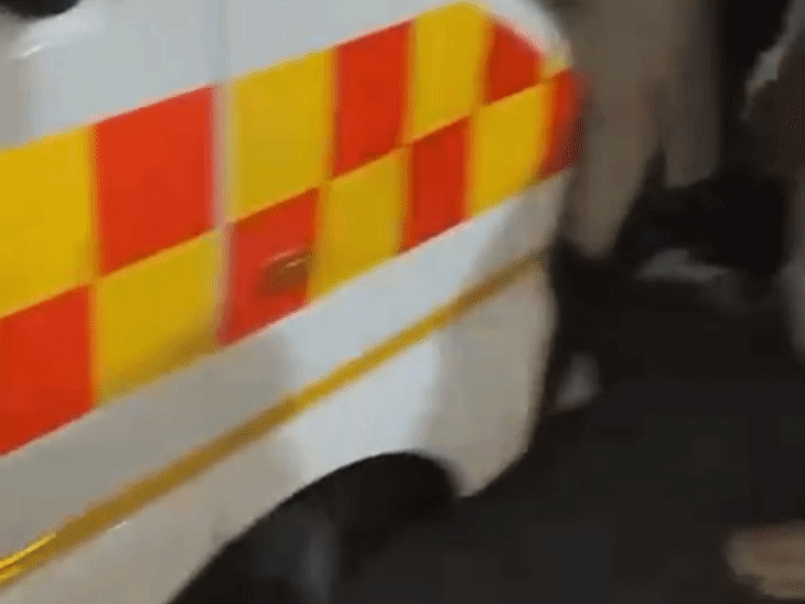 The ambulance and a crowd of people gathered there.