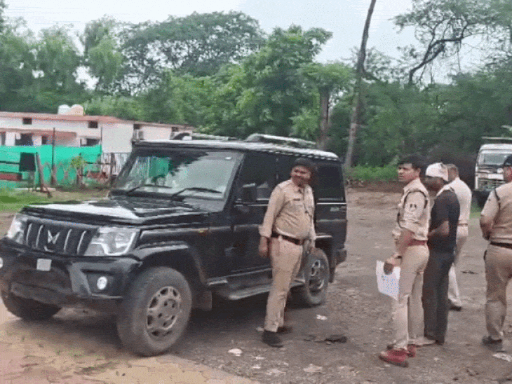 Police personnel investigating at the crime scene.