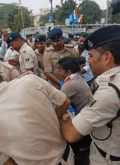 छात्रों को जबरन उठाकर सड़क से हटाती पुलिस टीम।