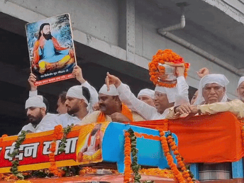 यात्रा के दौरान कलश को अपने सिर पर रखे हुए मंत्री महिपाल ढांडा।