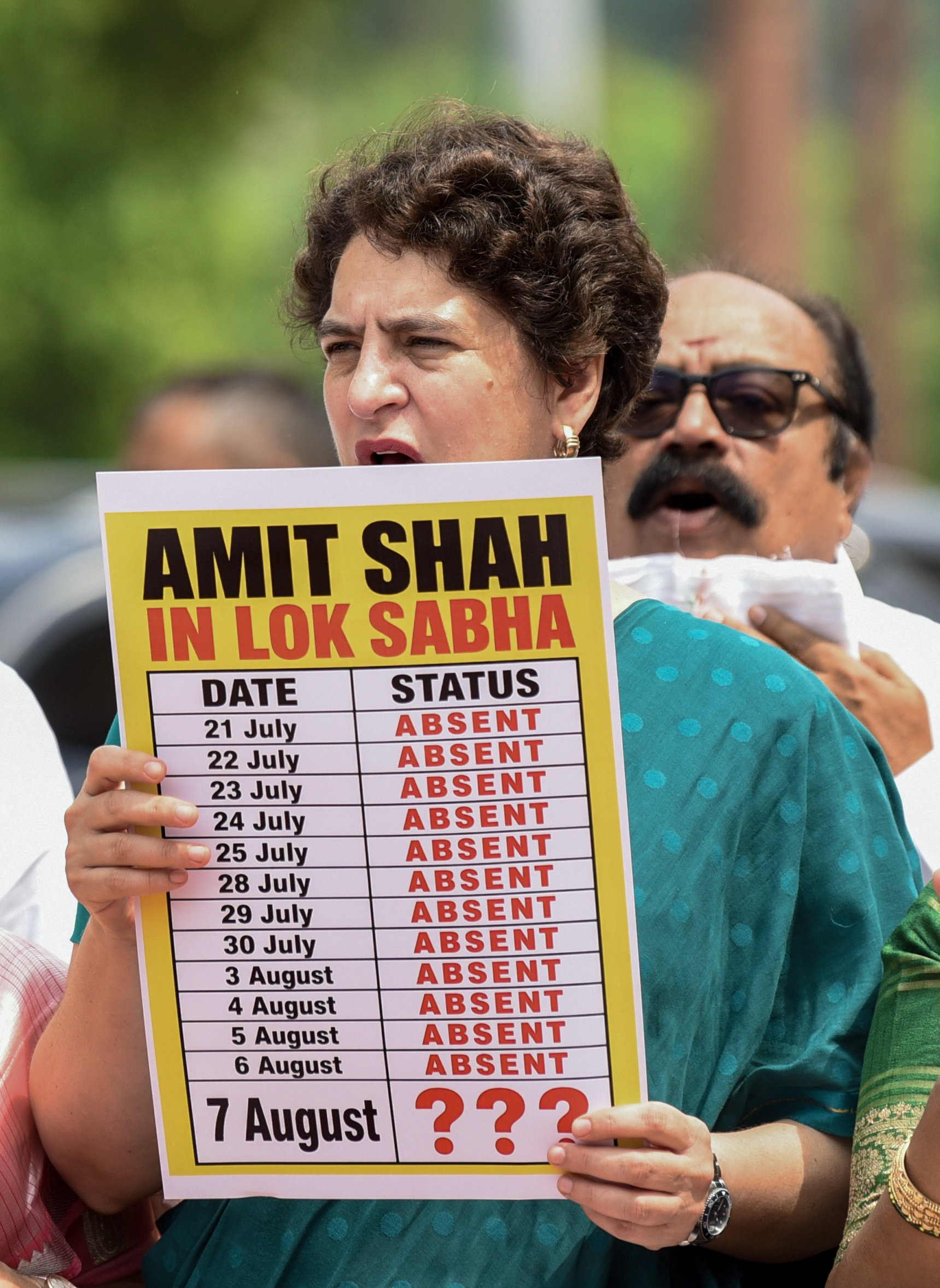 प्रदर्शन के दौरान प्रियंका गांधी ने हाथ में पोस्टर लिया था, जिस पर शाह की लोकसभा में गैरहाजिरी की तारीखें दर्ज थीं।
