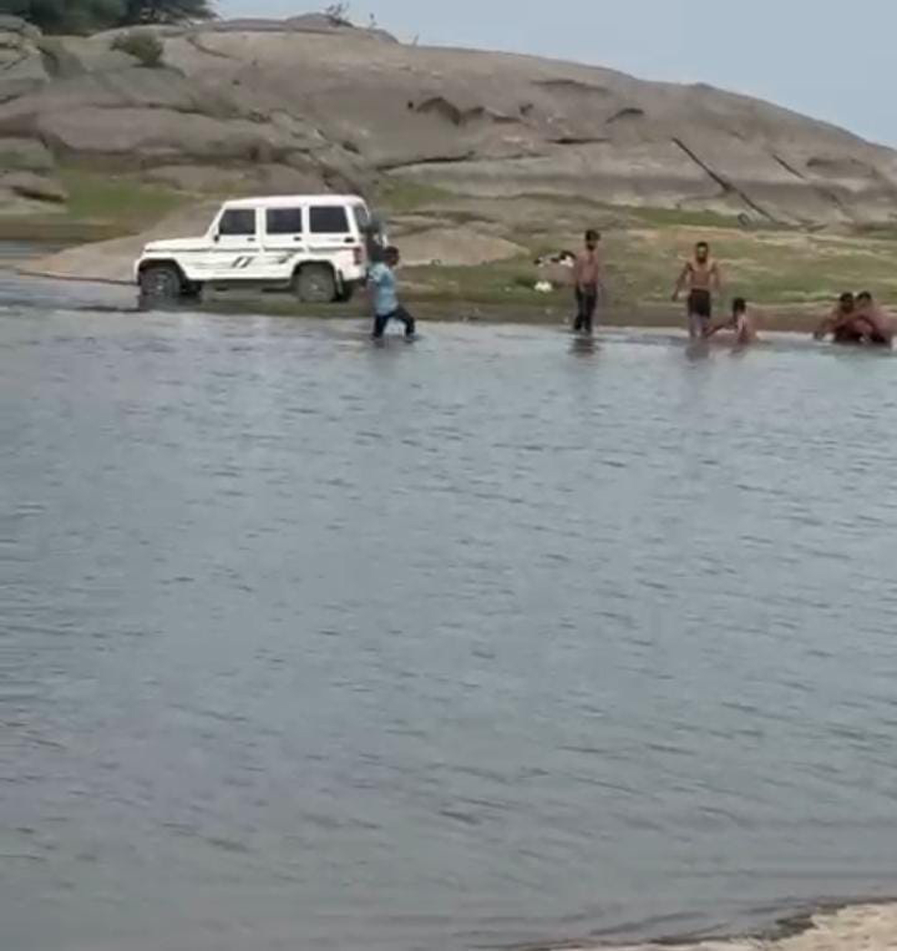 Ignoring the danger of crocodiles, people bathe in Jawai Dam.