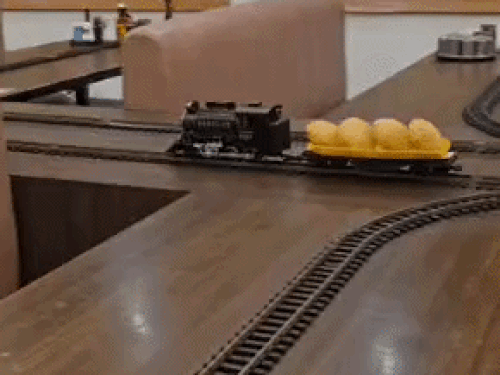 A train system has been installed to serve food at the dhaba. Its tracks are connected to several tables.