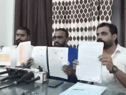 पत्रकारों को दस्तावेज दिखाते हुए मंजीत मोखरा व विक्रम डूमोलिया।