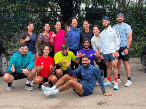 The entire team of runners is stopped when they run on the road in DLF area.