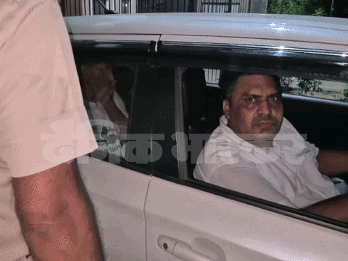 Police taking away the accused after arrest.