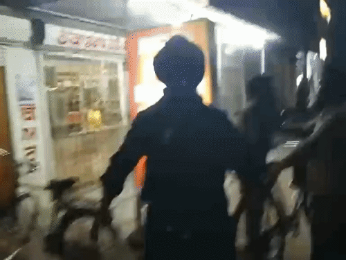 Nihangs beating youths who were drinking alcohol in the open outside the liquor store.