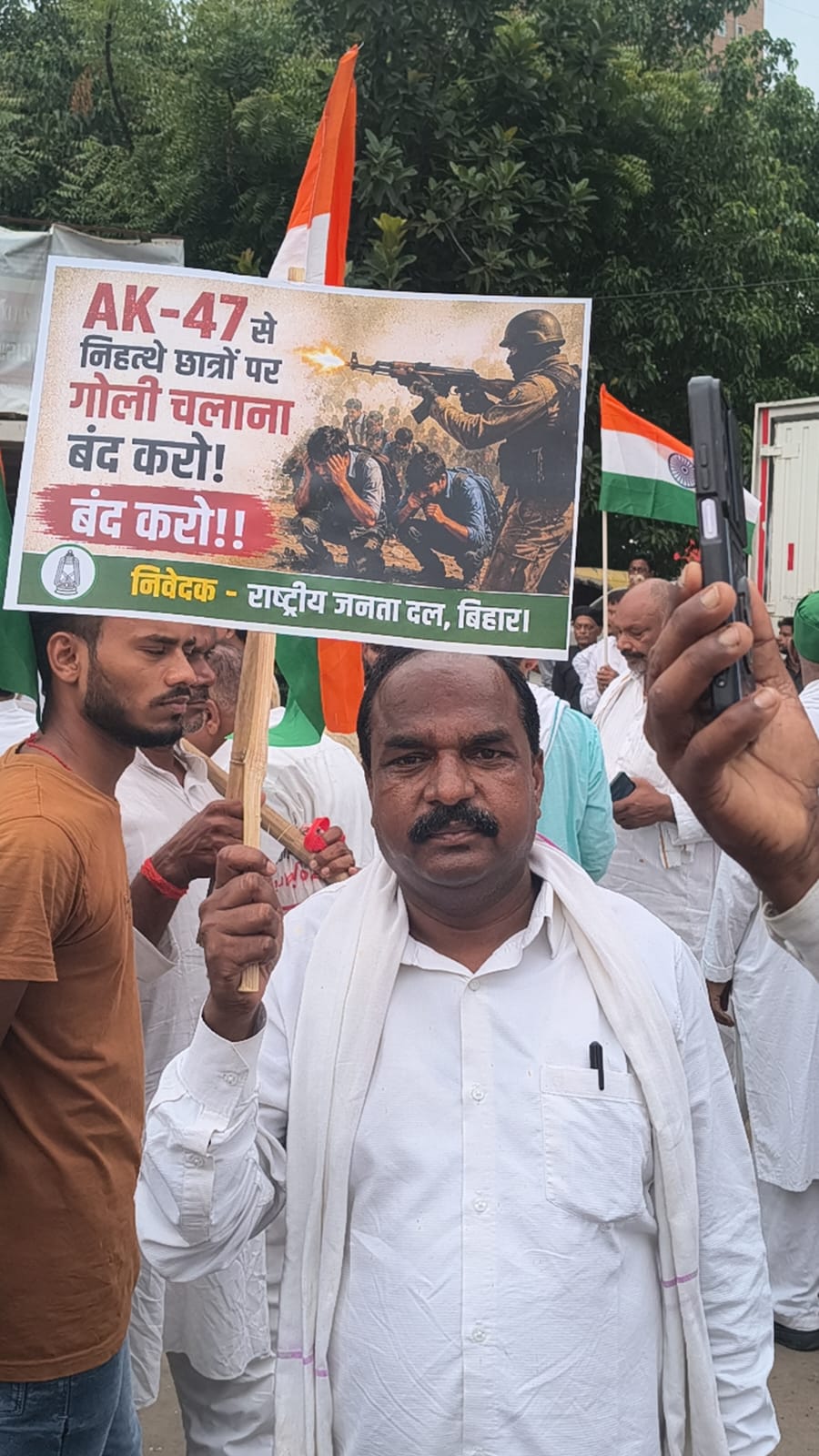 A worker arrived at the march with a poster reading "Stop firing AK-47s at unarmed students."