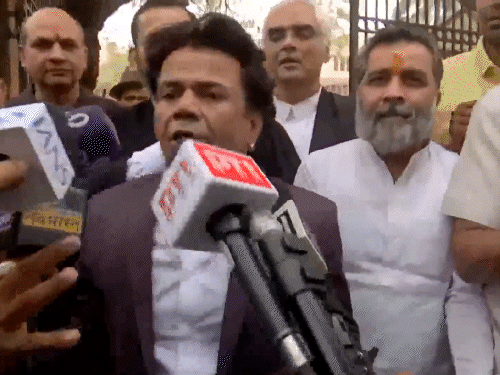 Rajpal talking to the media outside the court in the check bounce case.