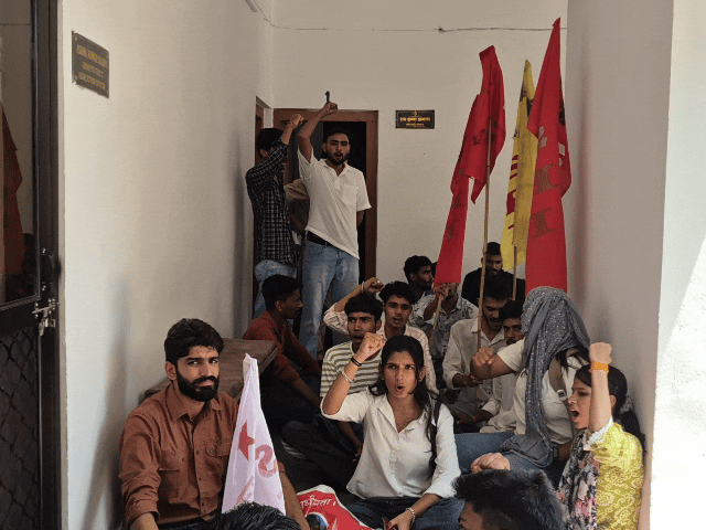मुख्य जिला शिक्षा अधिकारी के ऑफिस के बाहर हंगामा करते हुए प्रदर्शनकारी।
