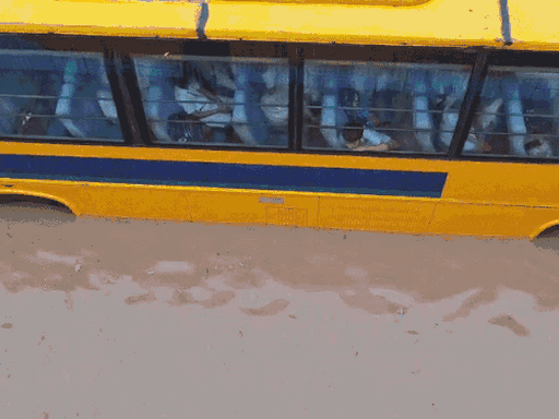 Children inside a school bus stranded at Subhash Chowk in Gurugram, Haryana, amid torrential rain.
