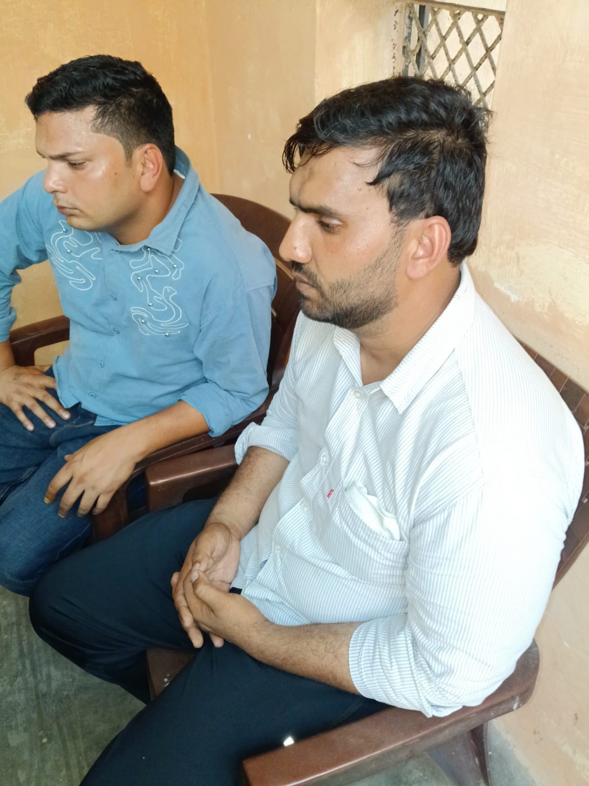 Patwari Subhash (in the blue shirt) and his associate Usman (in the white shirt) in the custody of the Panipat ACB.
