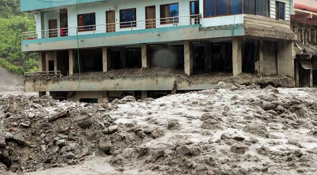 त्रिशूली में बाढ़ के कीचड़ और मलबे से घिरी एक क्षतिग्रस्त इमारत।