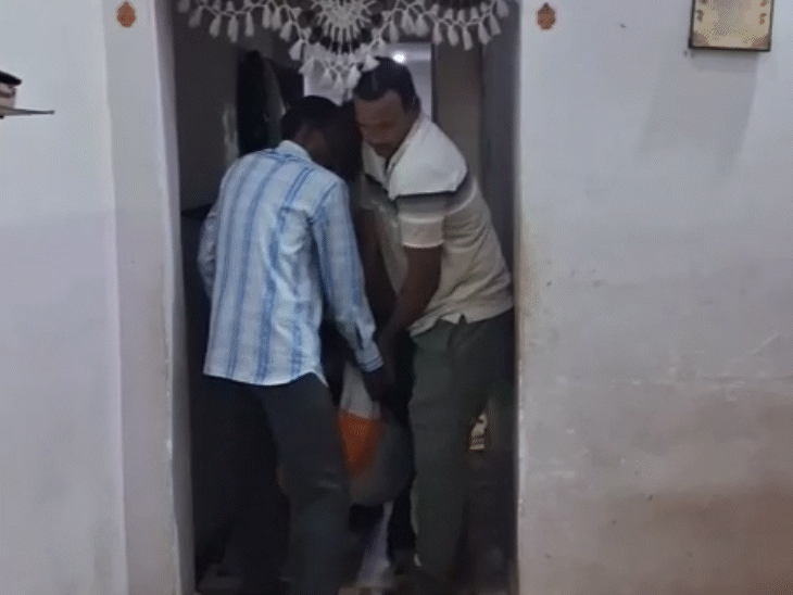 शव को घर से बाहर निकालने की तस्वीर।
