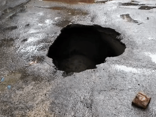 In Lucknow, UP, a road developed a 10-foot-deep sinkhole due to rain. A bike rider fell into it and was seriously injured.
