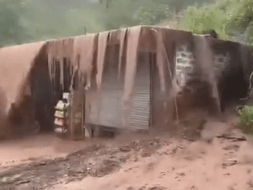 Water flowing over a shop after heavy rain in Jabli, Dharampur, Himachal Pradesh.