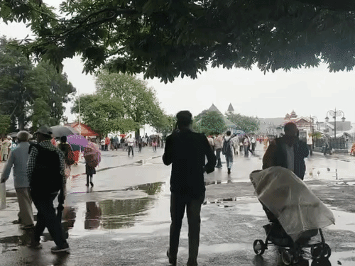 Tourists and local people out sightseeing in Shimla after the rain in the afternoon.
