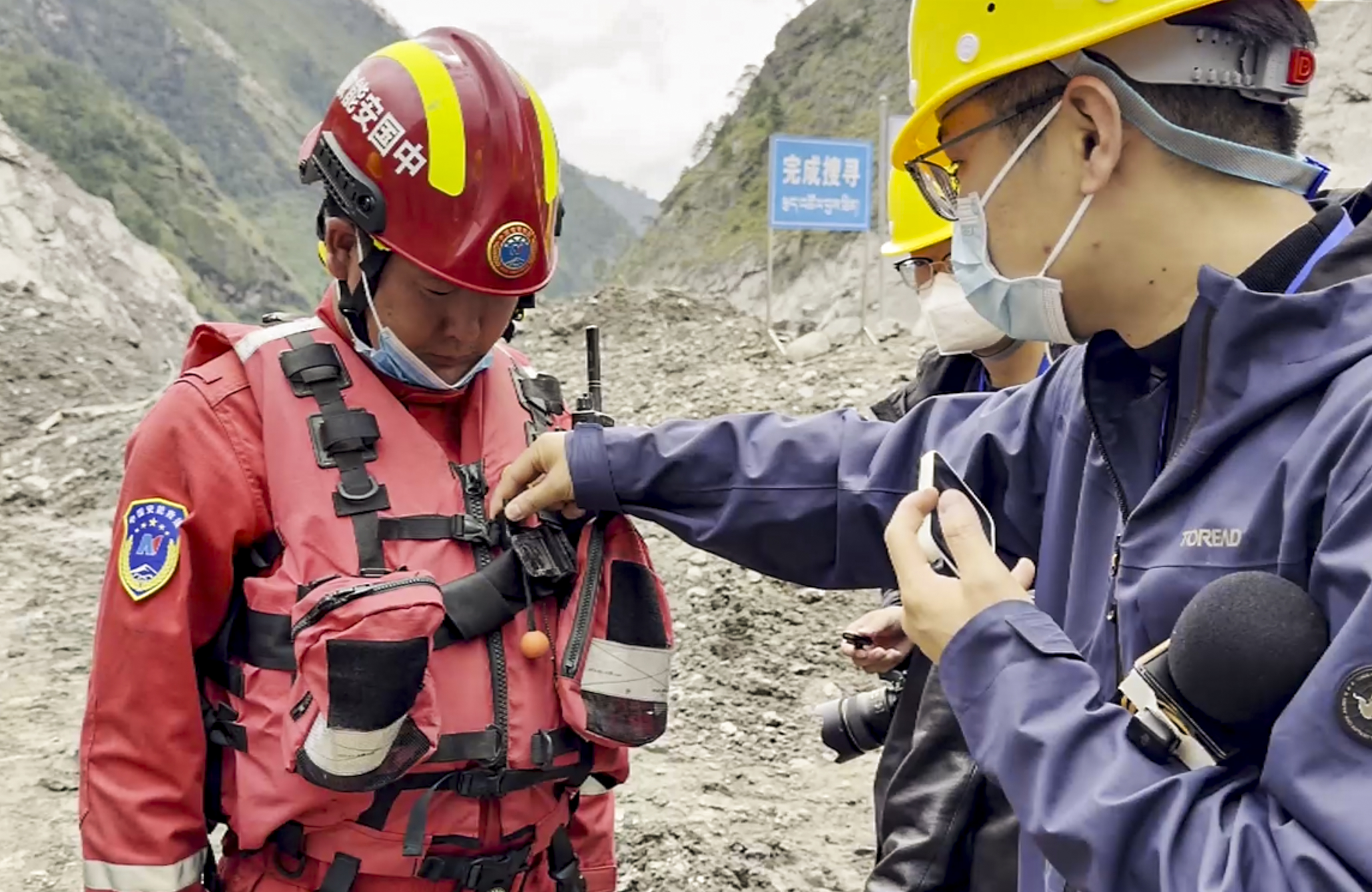 Rescue workers removing debris from the site of the immigration building that was washed away in the flood on the China-Nepal border.