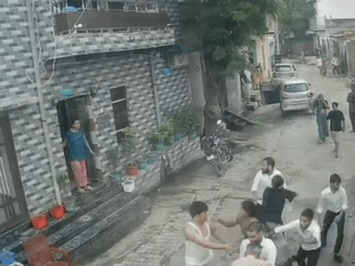 युवक के हाथ से लाठी छीनने का प्रयास करती सोल्जर की बहन।