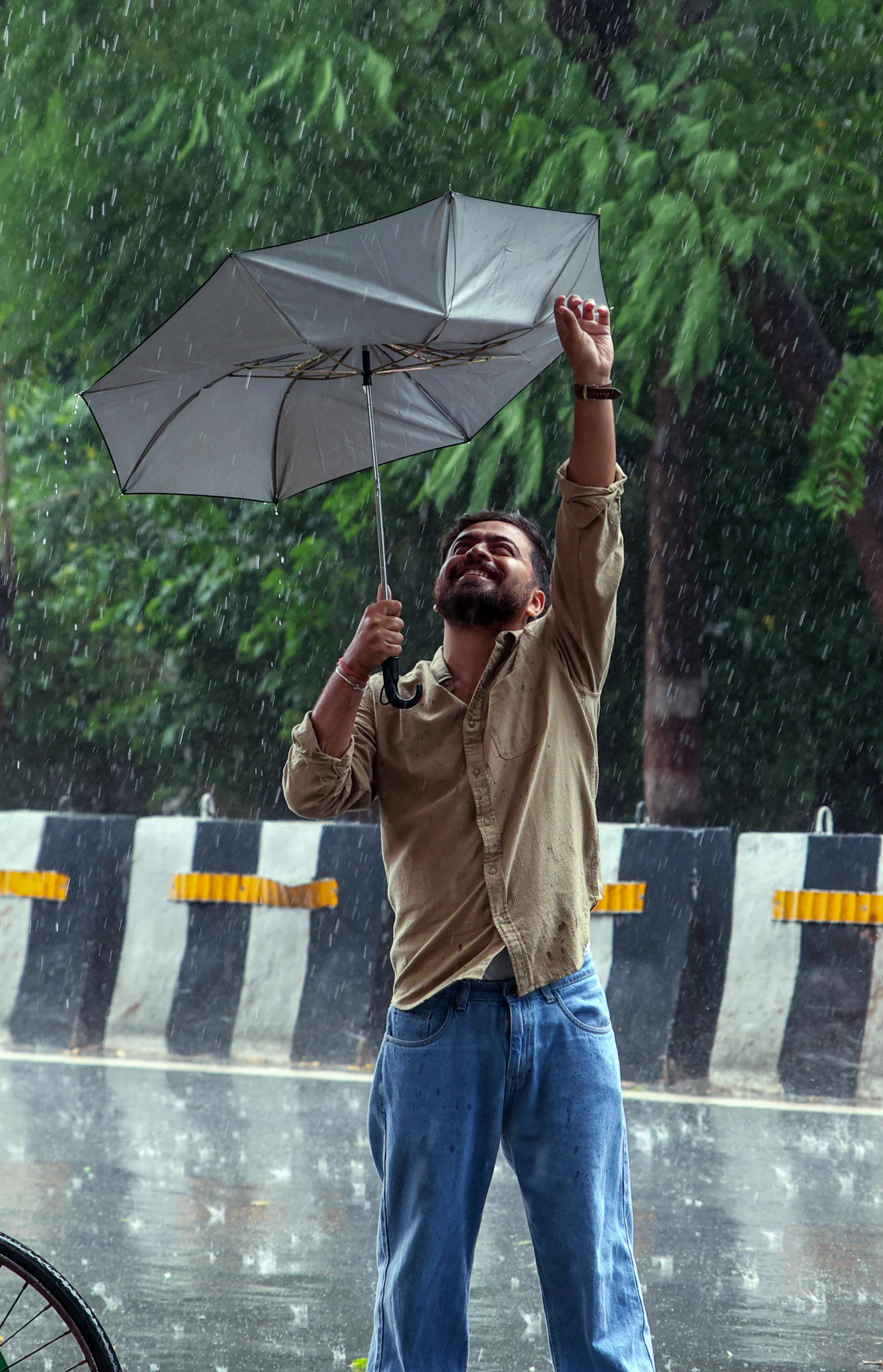 Strong winds also swept through Uttar Pradesh capital Lucknow on Thursday, with a man seen trying to stop his umbrella from being blown away.