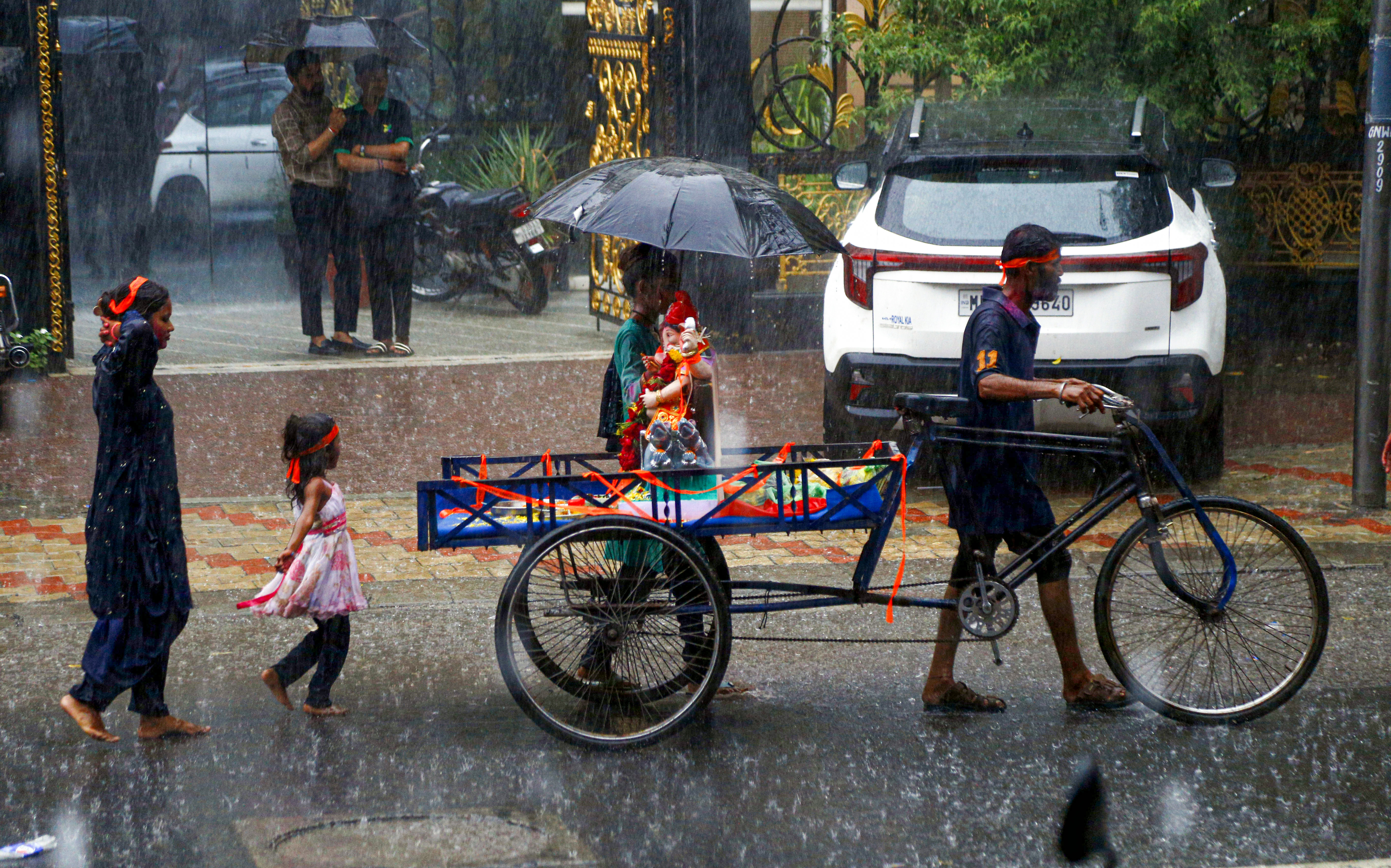 Heavy rain lashed Ahmedabad on Sunday. Meanwhile, people were seen carrying an idol of Lord Ganesha for immersion.