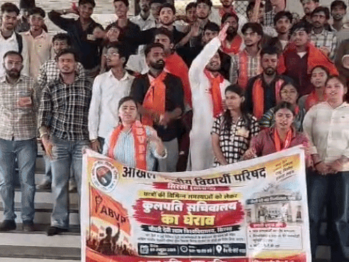 प्रशासनिक ब्लॉक के गेट पर प्रदर्शन करते हुए छात्र व छात्राएं।