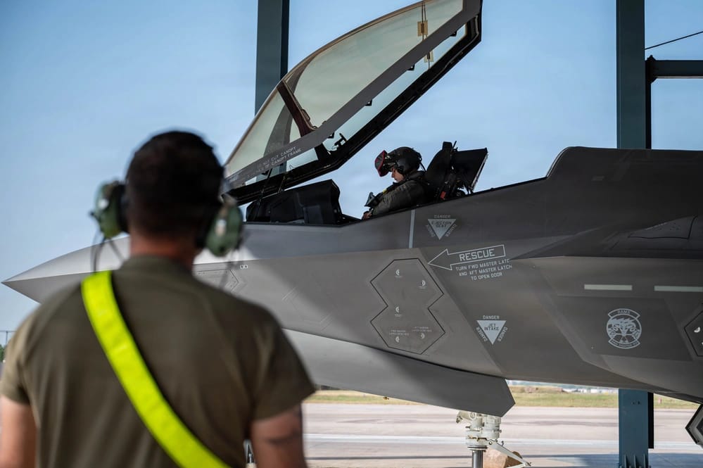 F-35A के कॉकपिट में पायलट, सामने अत्याधुनिक हेलमेट-माउंटेड डिस्प्ले सिस्टम। F-35 का हेलमेट पायलट को विमान के सेंसर और टारगेटिंग से जुड़ी महत्वपूर्ण जानकारी उपलब्ध कराने में मदद करता है। यही सेंसर फ्यूजन इसे पांचवीं पीढ़ी का खास लड़ाकू विमान बनाता है।