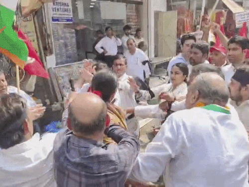 Congress office-bearers separating the two.