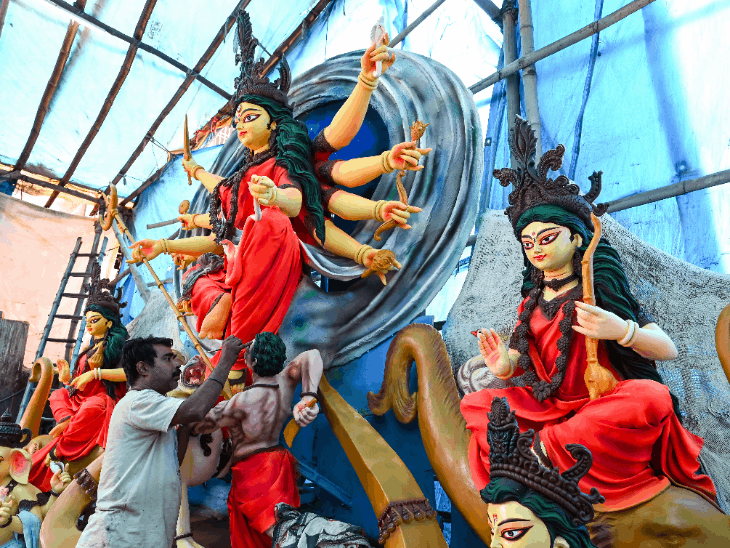 रांची में दुर्गा पूजा त्योहार से पहले एक वर्कशॉप में एक कारीगर देवी दुर्गा की मूर्ति को अंतिम रूप दे रहा है।