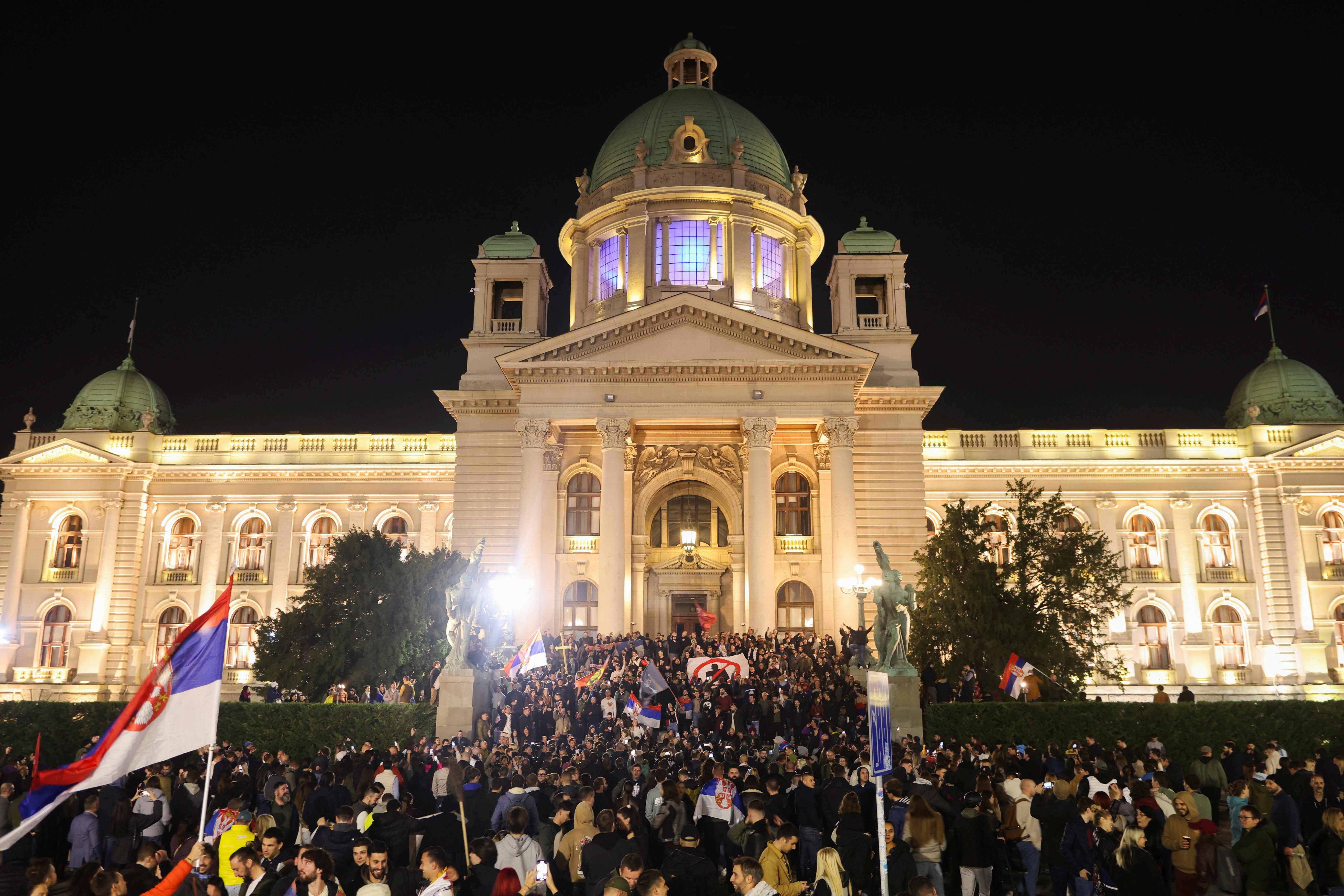 Supporters of 'Student List' celebrate election victory outside the Parliament building in Belgrade.