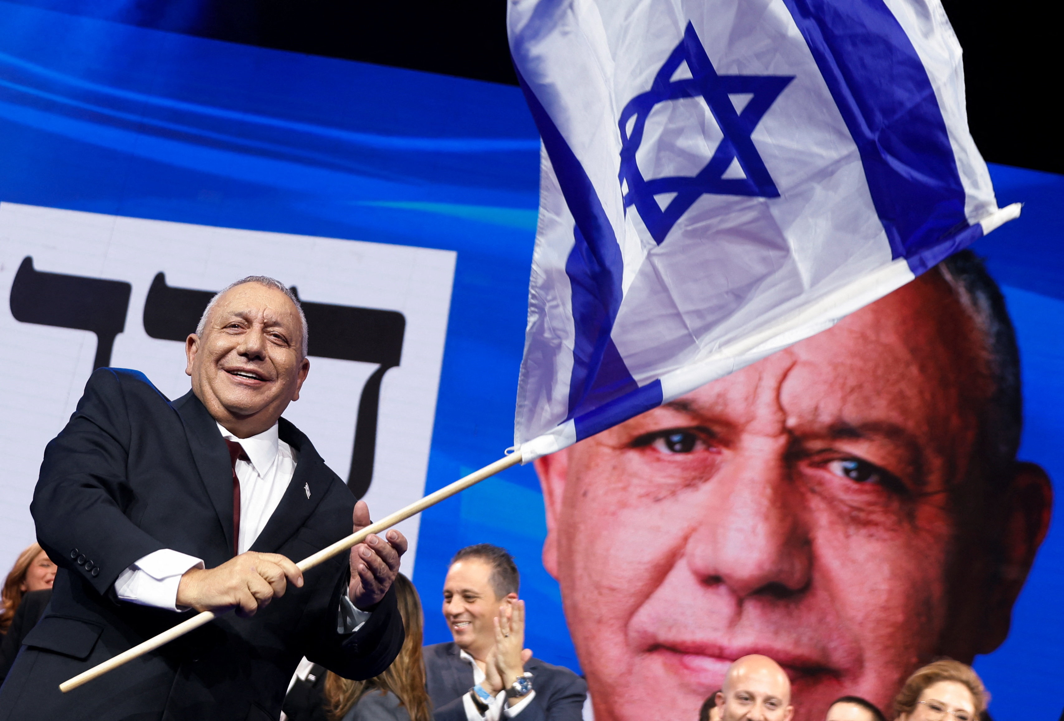 Yashar Party leader Gadi Eiseenkot waves the Israeli flag in Tel Aviv after preliminary election results were announced. The picture is of 28 October 2026.